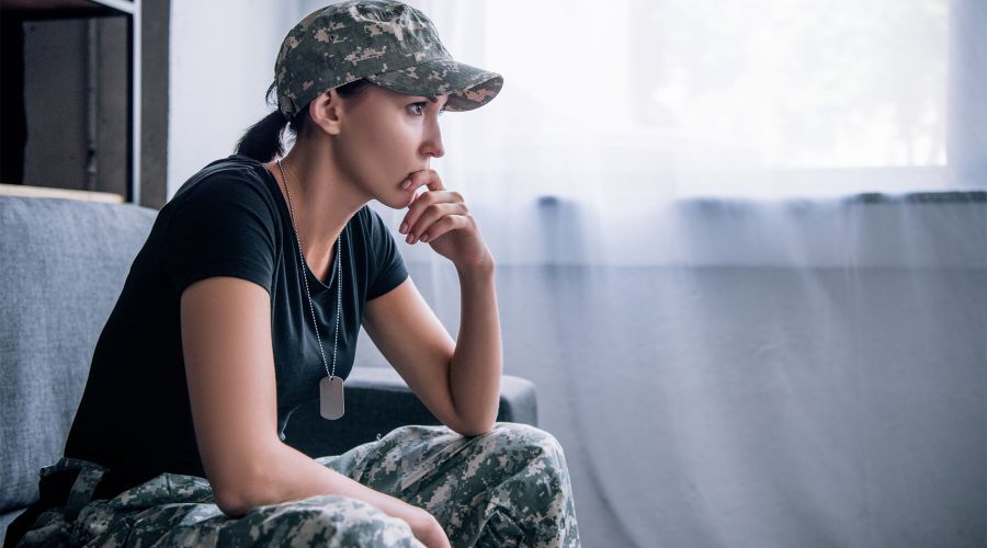 woman sitting down holding her chin